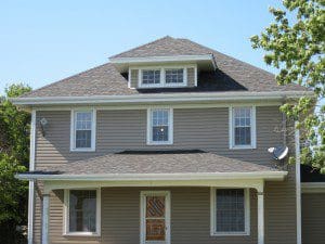 A two-story house with a gray roof.